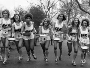 The start of the pancake race I/R Caroline Meade, Marilyn Ward, Gay Leary, Pauline Peart, Gaynor Lacey, Zone Spink Deidre Greenland and Sheila Mitchell. February 1975 P005074 The start of the pancake race I / R Caroline Meade, Marilyn Ward, Gay Leary, Pauline Peart