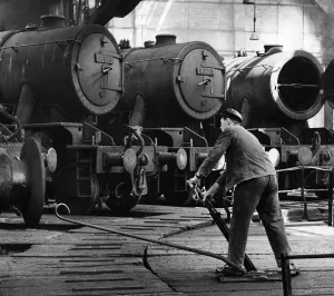 Steam Trains. A driver prepares to take his engine out of the sheds at the British Steam Trains. A driver prepares to take his engine out of the sheds at the British