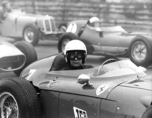 Stirling Moss sitting in Ferrari Dino racing car at Historic Car Championship Race at Stirling Moss sitting in Ferrari Dino racing car at Historic Car Championship Race at