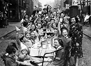 Streamers and flags are waved by residents of this Manchester street when fifty children Streamers and flags are waved by residents of this Manchester street when fifty children