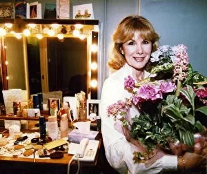 01429 Gallery: Susan Hampshire holding bouquet of flowers in her dressing room after appearing in Noel