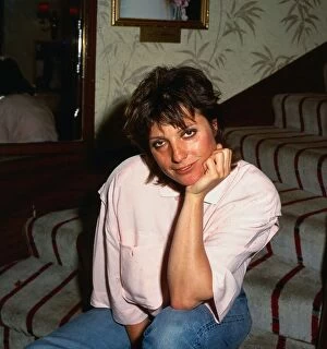 Suzanne Danielle August 1987 actress sitting on stairs hand at chin