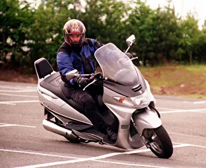 Suzuki Burgman 400 motorbike June 1999 being driven round corner Suzuki Burgman 400 motorbike June 1999 being driven round corner