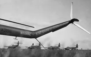 The tail of a Bristol Sycamore frames a flight of Meteors ready for take off at RAF The tail of a Bristol Sycamore frames a flight of Meteors ready for take off at RAF
