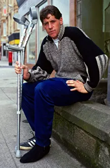 Ted McMinn sitting on wall with crutches September 1986 Ted McMinn sitting on wall with crutches September 1986