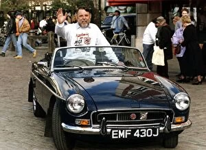 Terry Waite former Middle East hostage sitting in his MG sportscar