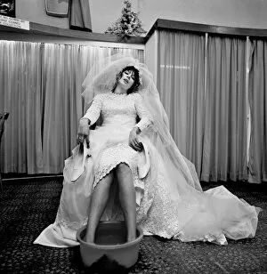 Images Dated 8th April 1970: The thing that every bride must long to do at the end of her greatest, happiest