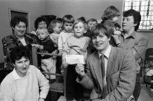 Images Dated 11th April 1989: Three-year-old Phillip Auckland presents a £50 cheque from Denby Dale Mothers'