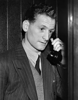 Tom Finney, who plays on the right wing, seems worried as he makes a midnight phone call Tom Finney, who plays on the right wing, seems worried as he makes a midnight phone call