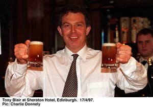 Images Dated 17th April 1997: Tony Blair holding two half pints of Blairs Brew beer in both hands. April 1997
