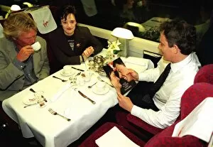 Images Dated 27th April 1997: Tony Blair MP reads Yes magazine sitting in dining carriage of train with wife Cherie