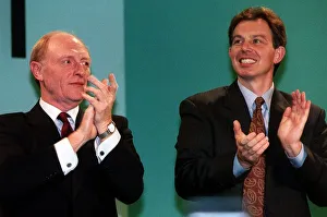 Tony Blair with Neil Kinnock clapping together Tony Blair with Neil Kinnock clapping together