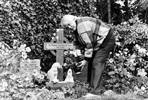 Images Dated 27th August 1987: Tony Booth actor and writer father of Cherie Blair tending a shrine to wife