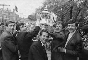 Tottenham Hotspur players celebrate with the FA Cup trophy on an open top bus parade in Tottenham Hotspur players celebrate with the FA Cup trophy on an open top bus parade in