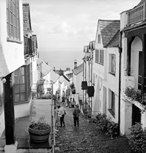 Tourists making their way down the steep hill in the village of Clovelly in North Devon Tourists making their way down the steep hill in the village of Clovelly in North Devon