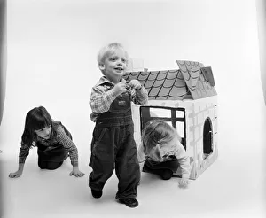 Toys: Children playing with a Wendy house made out of cardboard Toys: Children playing with a Wendy house made out of cardboard