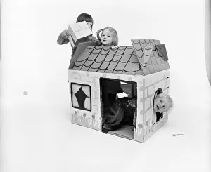 Toys: Children playing with a Wendy house made out of cardboard Toys: Children playing with a Wendy house made out of cardboard