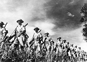 troops of a famous Indian regiment advancing in column through countryside in Malaya troops of a famous Indian regiment advancing in column through countryside in Malaya