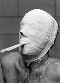 Tubes in his mouth help Ice Hockey goal minder Leif Holmquist to breathe as he waits for Tubes in his mouth help Ice Hockey goal minder Leif Holmquist to breathe as he waits for
