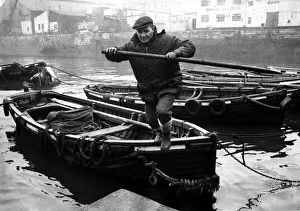 A Tyne foyboatman, member of a dying trade, ties up his boat alongside others at A Tyne foyboatman, member of a dying trade, ties up his boat alongside others at