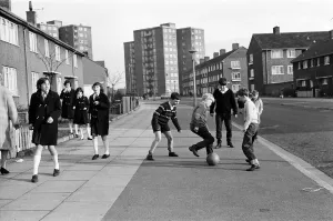 A typical street in Kirkby, Liverpool. Boys playing football in the street A typical street in Kirkby, Liverpool. Boys playing football in the street