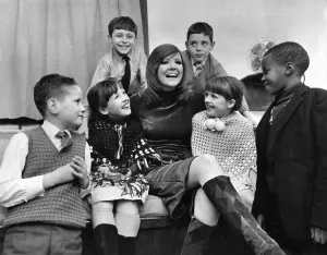Underpriviledged children at the Palladium. Singer Cilla Black wth six of the children Underpriviledged children at the Palladium. Singer Cilla Black wth six of the children