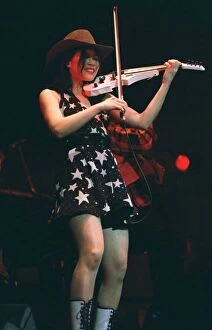 Images Dated 24th May 1995: Vanessa Mae on stage playing white violin wearing mini skirt