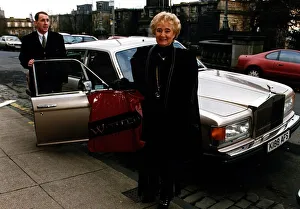 Vera Weisfeld standing beside Rolls Royce car holding plastic bag Weisfelds store Vera Weisfeld standing beside Rolls Royce car holding plastic bag Weisfelds store