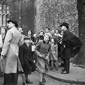Visitors to the Tower of London are showing around the castle by one of the resident Visitors to the Tower of London are showing around the castle by one of the resident