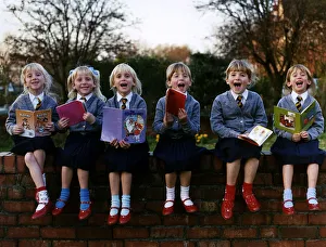 Walton Sextuplets holding story books while sitting on a wall DBase Walton Sextuplets holding story books while sitting on a wall DBase