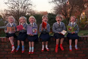 Walton sextuplets sitting on wall reading books weby Walton sextuplets sitting on wall reading books weby