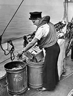 Life Jacket Gallery: Nothing to wasted at sea. Seaman placing waste in salvage tins so familiar to