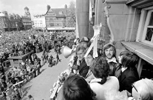 West Ham players including captain Billy Bonds show off the trophy to fans gathered below