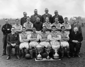 Wigan Athletics football team poses for a group photograph with their three cups Wigan Athletics football team poses for a group photograph with their three cups