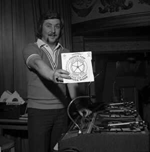 Disc Jockey Collection: Wigan Casino dancers 1975 Northern Soul DJ Russ Winstanley holds up a 45 single