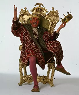 William G Stewart TV Presenter June 1986 dressed as a king sitting on a throne
