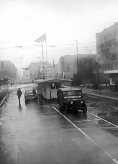A wind swept rainy day at Checkpot Charlie on Berlin Friedrich strasse A wind swept rainy day at Checkpot Charlie on Berlin Friedrich strasse