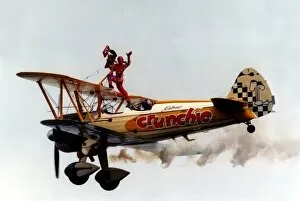 Images Dated 1st August 1997: A wing walker performs on the Cadburys Crunchie Boeing-Stearman Model 75 biplane at