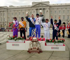 Winners Dionicio Ceron and Katrin Dorre on the podium holding their trophies after Winners Dionicio Ceron and Katrin Dorre on the podium holding their trophies after