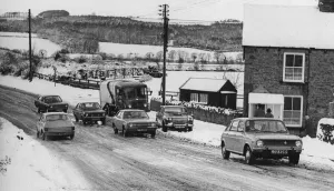 A winter snow scene, 28th March 1977. Cars struggle up a bank at Birches Nook A winter snow scene, 28th March 1977. Cars struggle up a bank at Birches Nook