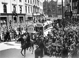 Wolverhampton Wanderers players show the FA Cup trophy to their fans from atop an open Wolverhampton Wanderers players show the FA Cup trophy to their fans from atop an open