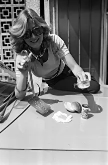Images Dated 25th June 1976: A woman cooks an egg on a car bonnet during the 1976 heatwave. 25th June 1976