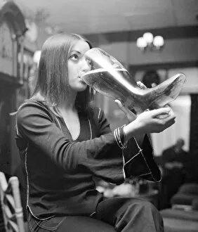 Images Dated 20th December 1972: Woman drinking from a glass boot holding nearly 5 pints of lager