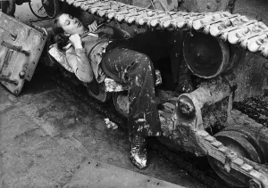 A woman in a Ministry of Supply munitions depot works on the catapillar track of a tank A woman in a Ministry of Supply munitions depot works on the catapillar track of a tank