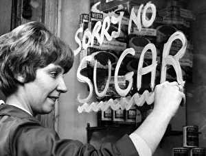 A woman paints a Sorry No Sugar sign on a shop window in Liverpool A woman paints a Sorry No Sugar sign on a shop window in Liverpool