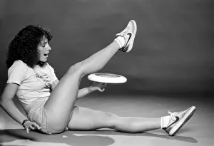 A woman performing exercises with a frisbee. June 1980 A woman performing exercises with a frisbee. June 1980