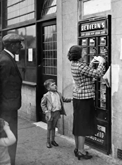 A woman seen here using the Automatic Fish and Chip dispenser at Redfern' A woman seen here using the Automatic Fish and Chip dispenser at Redfern'