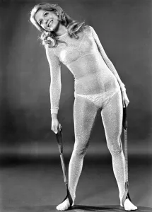 Images Dated 2nd January 1971: Woman wearing bra and knickers and see through dress stretching as part of her fitness