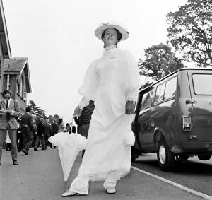 Images Dated 16th June 1970: Woman wearing long white dress with matching hat and umbrella on the first day of Royal