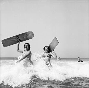 Holidaymakers Gallery: Women body boarding in the surf at Newquay June 1960 M4303-002